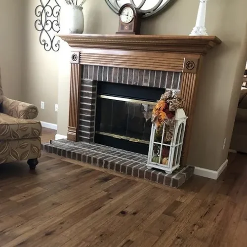 Warm plank flooring running through a finished open living space with white trim.